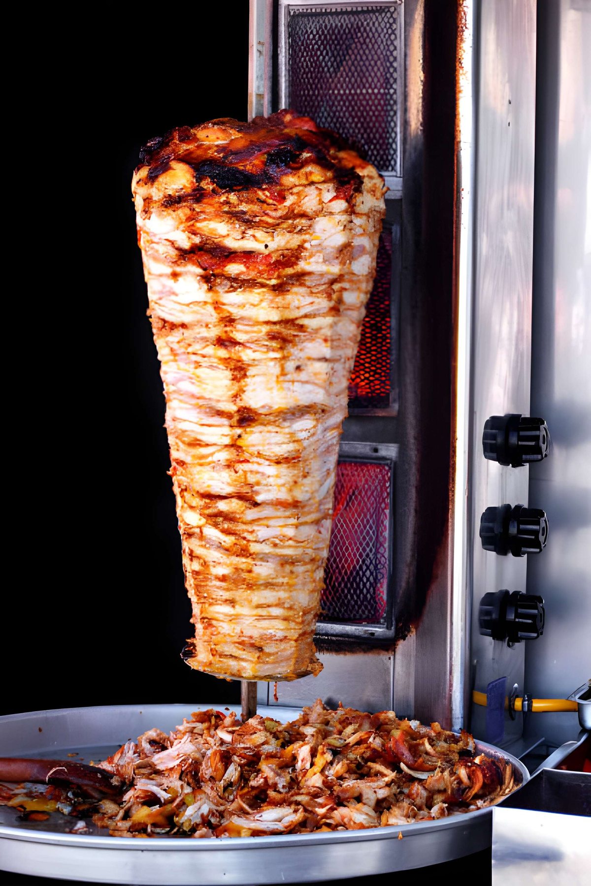 Doner kebab turning in front of the grill in the shop